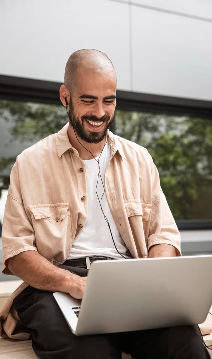 man smiling with laptop